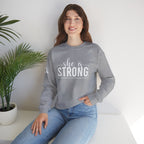 She is STRONG - Unisex Heavy Blend™ Crewneck Sweatshirt - Front White Logo - Plain Back