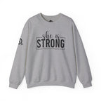 She is STRONG - Unisex Heavy Blend™ Crewneck Sweatshirt - Front Black Logo - Plain Back