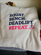 WWLW “Squat • Bench • Deadlift • Repeat” Hoodie - Front Dark Logo Plain Back