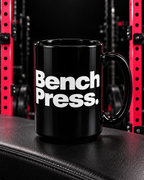 Bench Press black 15oz mug in the WWLW gym