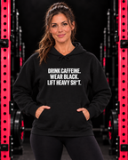 Woman facing forward wearing black Drink Caffeine front-print pullover hoodie