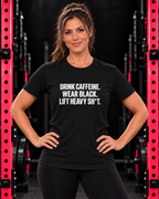 Front-facing woman wearing black women’s Softstyle tee with white Drink Caffeine collection print