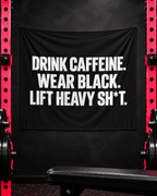 Black Drink Caffeine wall tapestry displayed between red-pink gym racks