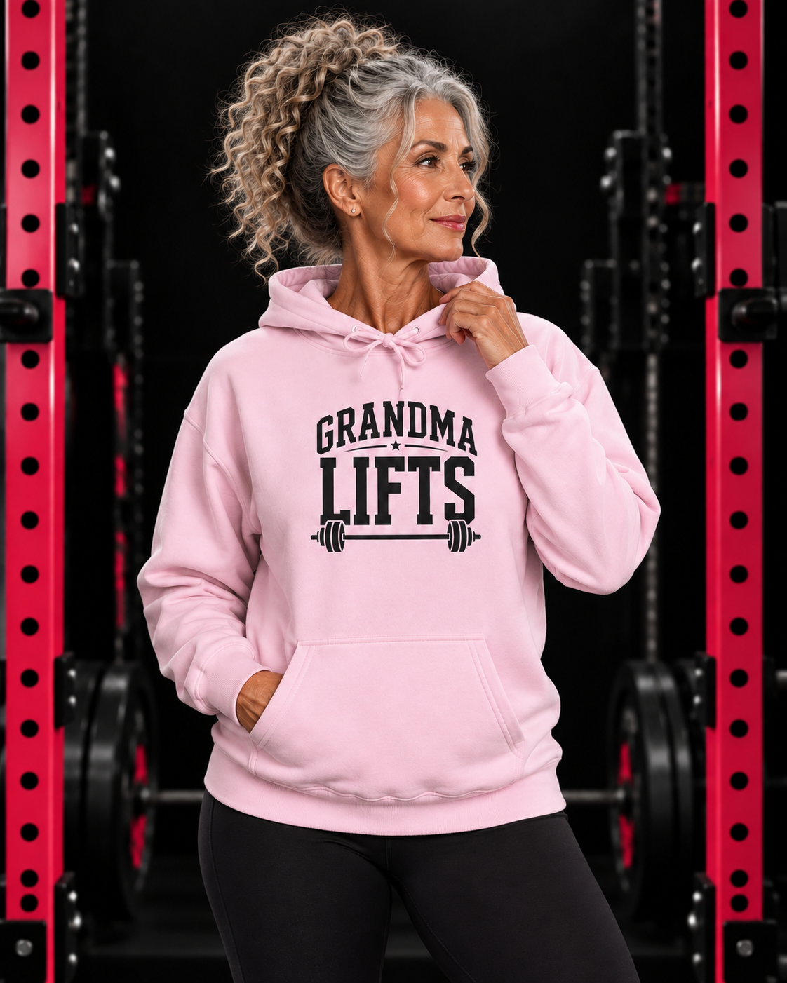 Grandma Lifts black front logo light pink hoodie on mature woman in gym