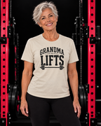 Grandma Lifts black front logo natural tee on a mature woman in the gym