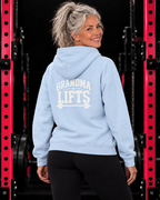 Grandma Lifts light blue hoodie on a mature woman in the gym
