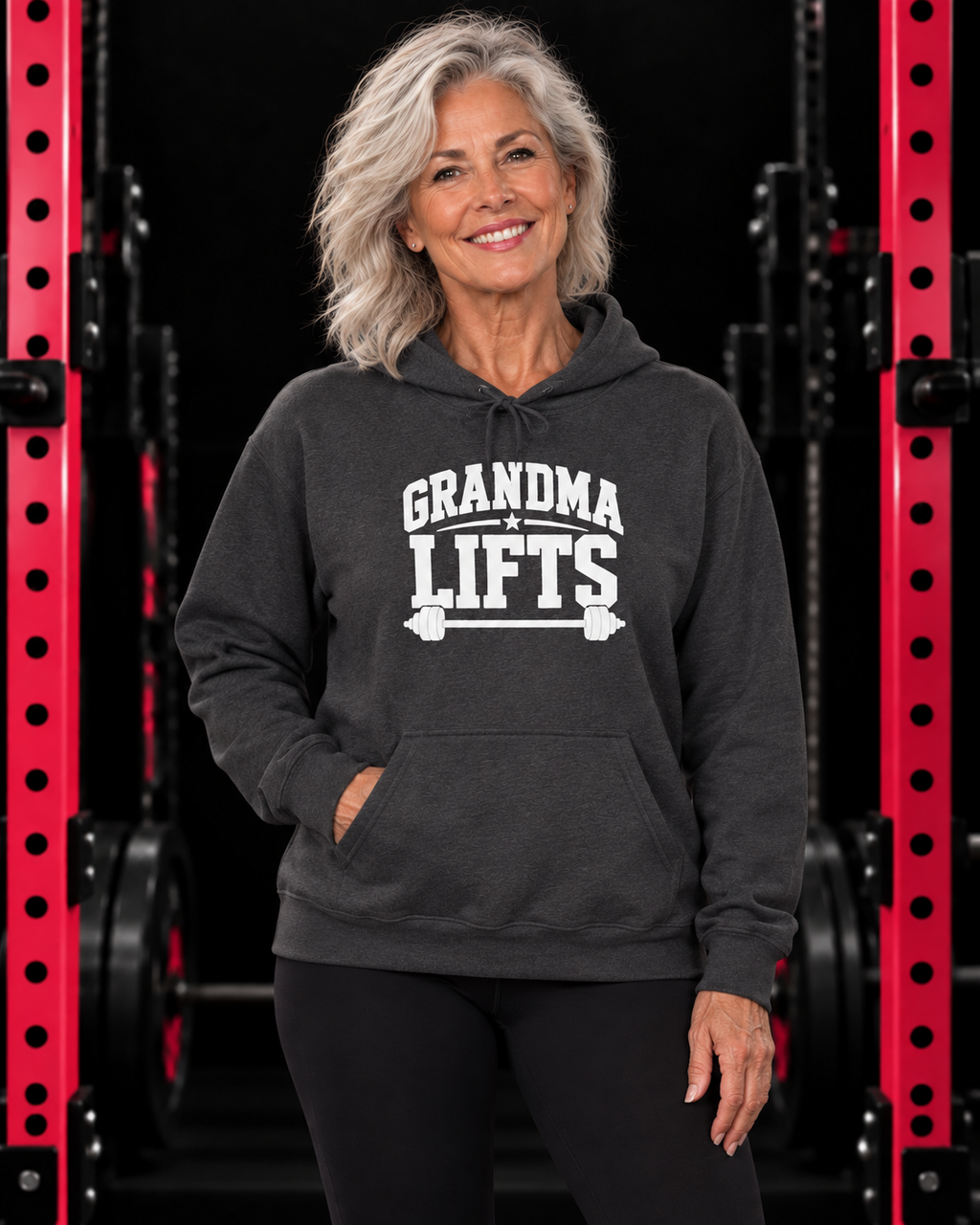 Grandma Lifts white front logo hoodie in Dark Heather on a woman over 60 in the WWLW gym
