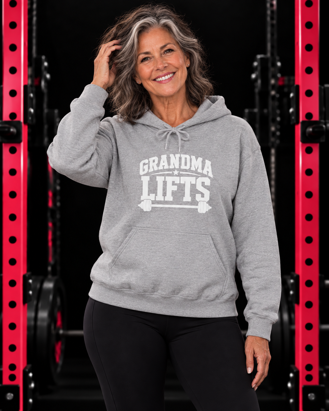 Grandma Lifts white front logo hoodie in sport grey on a mature woman in the WWLW gym