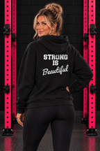 Black Strong Is Beautiful hoodie back print, female model between pink squat rack uprights