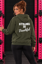 Military Green Strong Is Beautiful hoodie back print, female model between pink squat rack uprights