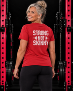 Strong Not Skinny white distressed back logo red tee on strong woman