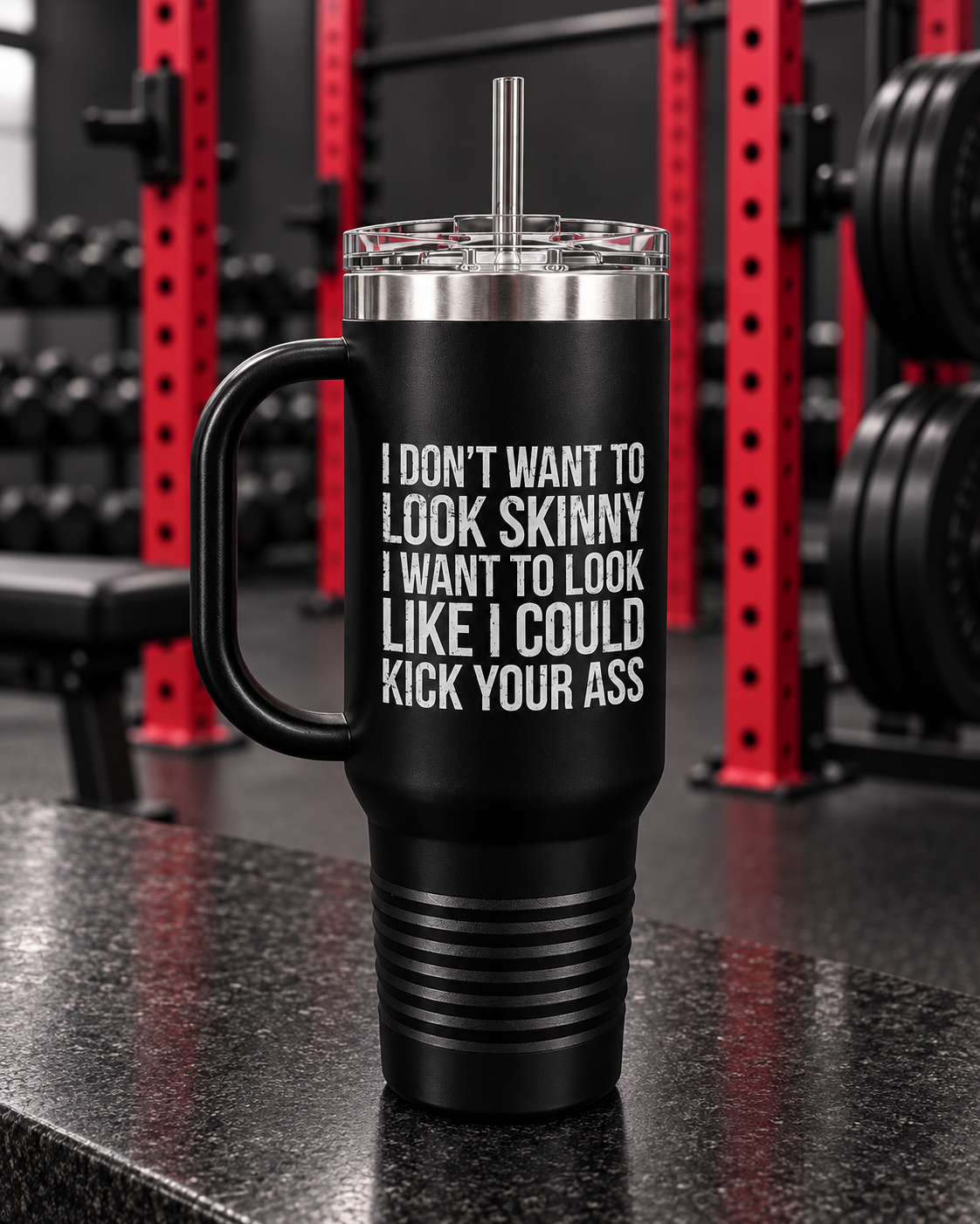 I Don't Want To Look Skinny I Want To Look Like I Can Kick Your Ass - 40oz Insulated Travel Mug — portrait product photo on a charcoal counter in the WWLW gym