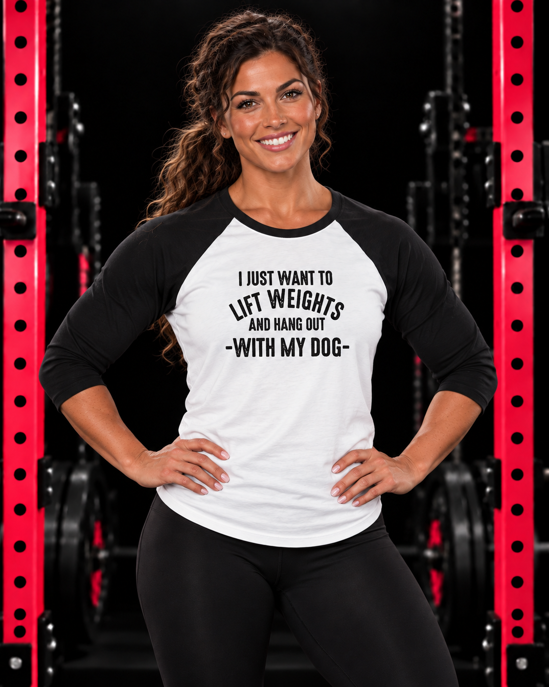 Athletic woman modeling 3\4 Sleeve Baseball Tee - Lift Weights & Hang Out With My Dog in a dark gym with red squat racks