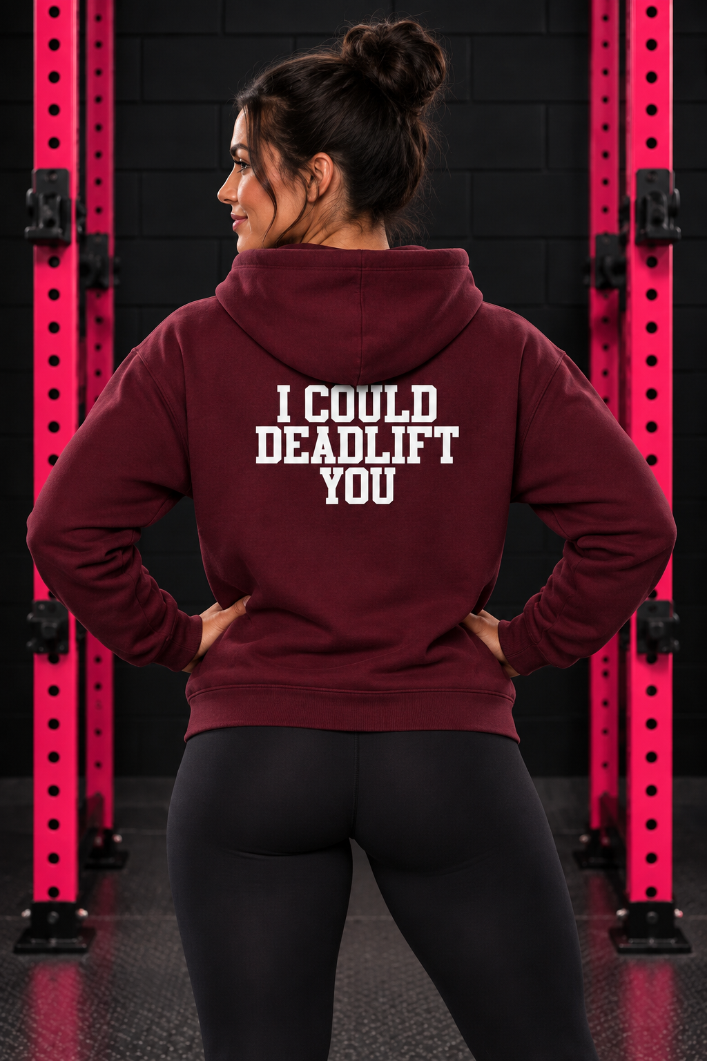 Back view of woman wearing maroon WWLW hoodie with white I Could Deadlift You print in black and pink gym