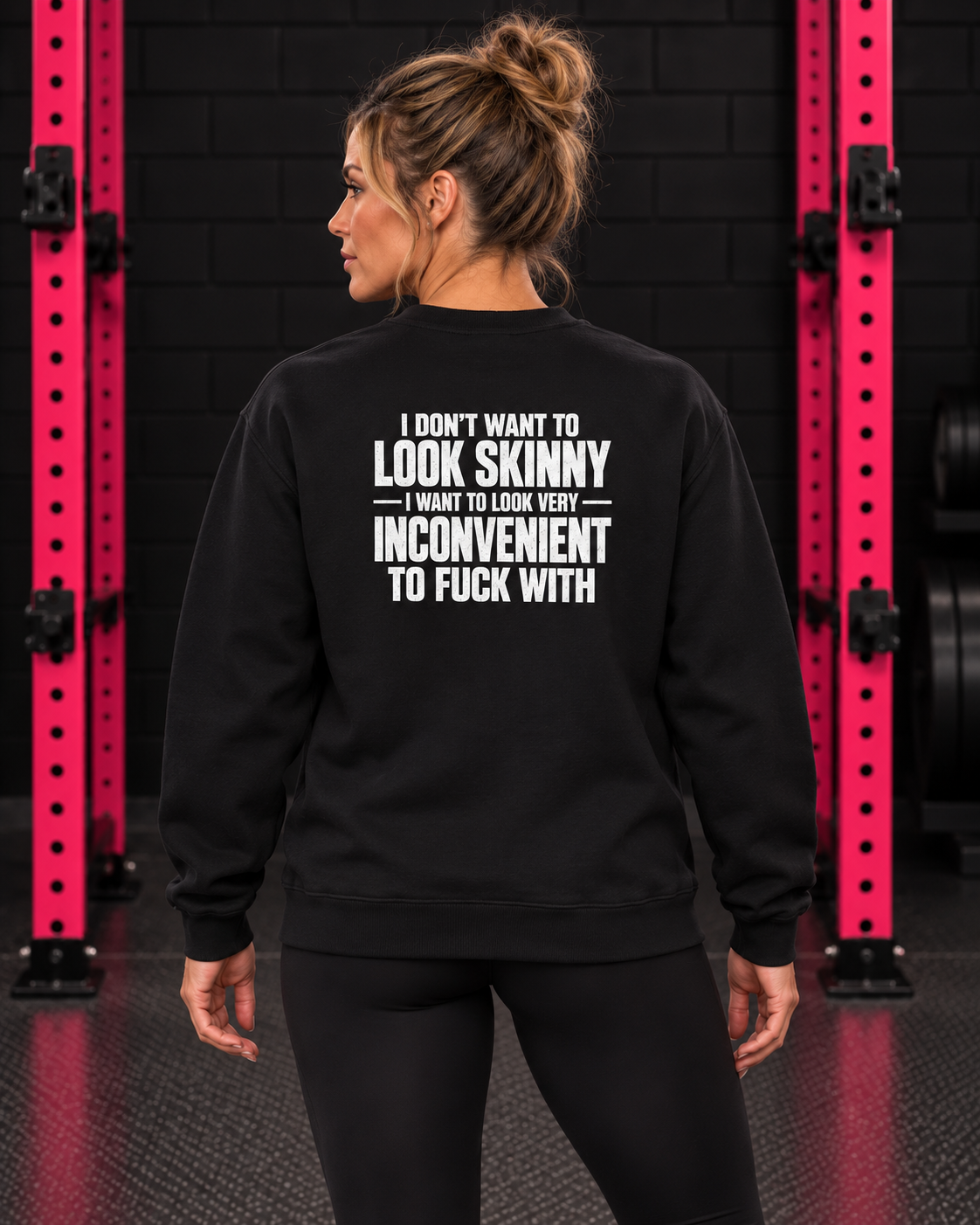 Black sweatshirt with white slogan back print, modeled in the WWLW black brick and hot-pink rack gym.