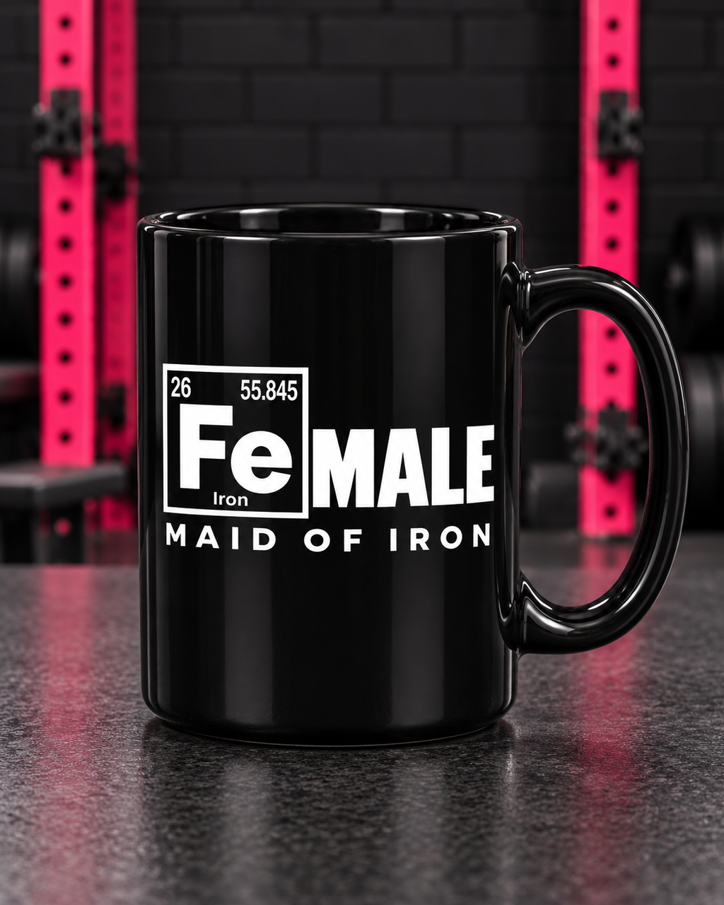 Maid of Iron white artwork on a black 15oz mug in the WWLW gym